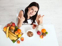 Beautiful women exists with pure skin on her face sitting at a table and eat breakfast. Asian woman eating healthy food at royalty free stock photo Beautiful women exists with pure skin on her face sitting at a table and eat breakfast. Asian woman eating healthy food at royalty free stock photo