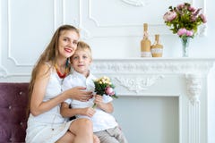 Woman is sitting on the couch with her son and daughter stock photos Woman is sitting on the couch with her son and daughter stock photos