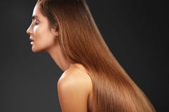 Beautiful yong woman with long straight brown hair. fashion model with smooth gloss hairstyle. Keratine Treatment stock photography Beautiful yong woman with long straight brown hair. fashion model with smooth gloss hairstyle. Keratine Treatment stock photography