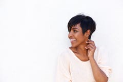 Beautiful young african woman smiling by white background stock images Beautiful young african woman smiling by white background stock images