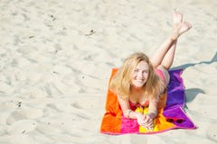 Beautiful young blond woman lying on a beach royalty free stock photography Beautiful young blond woman lying on a beach royalty free stock photography