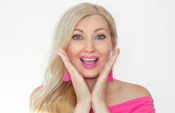 A beautiful young blonde with a surprised smile and holding her hands in front of her face, opening her mouth. royalty free stock photography A beautiful young blonde with a surprised smile and holding her hands in front of her face, opening her mouth. royalty free stock photography