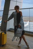 Beautiful young woman at the airport with a yellow suitcase and blue backpack. royalty free stock images Beautiful young woman at the airport with a yellow suitcase and blue backpack. royalty free stock images