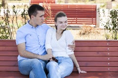 Beautiful young couple sitting on a bench in the park royalty free stock photography Beautiful young couple sitting on a bench in the park royalty free stock photography