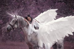 Beautiful, young elf, walking with a unicorn. She is wearing an incredible light, white dress. Art hotography