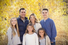 Beautiful Young Family Portrait with fall colors in the background stock images Beautiful Young Family Portrait with fall colors in the background stock images