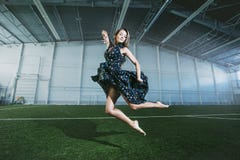 Beautiful young fashion model in a dress at a large sports stadium stock photography Beautiful young fashion model in a dress at a large sports stadium stock photography