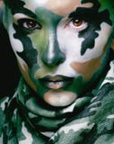 Beautiful young fashion woman with military style clothing and face paint make-up, khaki colors royalty free stock photos Beautiful young fashion woman with military style clothing and face paint make-up, khaki colors royalty free stock photos