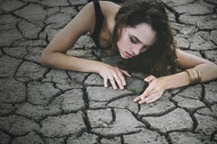 Beautiful young girl on the cracked earth in dress royalty free stock photography Beautiful young girl on the cracked earth in dress royalty free stock photography