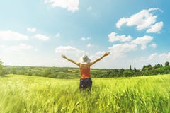 Beautiful young girl enjoying hot summer day in the middle of the field of hops with hands wide open and big white hat royalty free stock photos Beautiful young girl enjoying hot summer day in the middle of the field of hops with hands wide open and big white hat royalty free stock photos