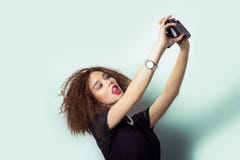 Beautiful Young Girl Hipster Takes Photos, Shoots Selfe, Taking Pictures Of Himself On Camera In Jeans And A Black T-shirt Stock Photos Beautiful Young Girl Hipster Takes Photos, Shoots Selfe, Taking Pictures Of Himself On Camera In Jeans And A Black T-shirt Stock Photos