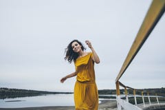 Beautiful young happy girl is walking along the railing of a con royalty free stock photography Beautiful young happy girl is walking along the railing of a con royalty free stock photography