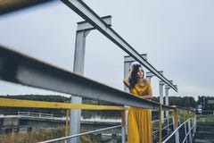 Beautiful young happy girl is walking along the railing of a con royalty free stock image Beautiful young happy girl is walking along the railing of a con royalty free stock image