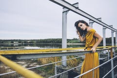 Beautiful young happy girl is walking along the railing of a con royalty free stock photography Beautiful young happy girl is walking along the railing of a con royalty free stock photography