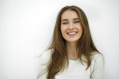 Beautiful Young Happy Woman Posing Against A White Wall Royalty Free Stock Images