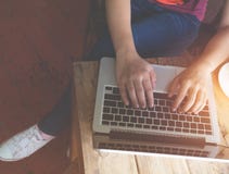 beautiful young hipster woman`s hands busy working on her laptop sitting at wooden table in a coffee shop Royalty Free Stock Images beautiful young hipster woman`s hands busy working on her laptop sitting at wooden table in a coffee shop Royalty Free Stock Images