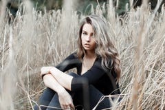 Beautiful young pretty woman blonde in stylish jeans in a fashionable black shirt is resting royalty free stock images Beautiful young pretty woman blonde in stylish jeans in a fashionable black shirt is resting royalty free stock images