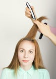 Beautiful young red-haired girl at the hairdresser makes blow drying, shorn bangs, hair polishing stock photography Beautiful young red-haired girl at the hairdresser makes blow drying, shorn bangs, hair polishing stock photography