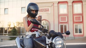 Beautiful Young Red-haired Woman Motorcyclist With Black Motorcycle Helmet Royalty Free Stock Photography