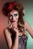 Beautiful young girl with lush hair in theatrical retro look with red hat in her hair bright makeup and big lips in the Studi stock photo Beautiful young girl with lush hair in theatrical retro look with red hat in her hair bright makeup and big lips in the Studi stock photo