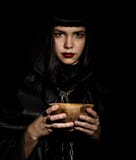 Beautiful young witch with a candle of spells royalty free stock photography Beautiful young witch with a candle of spells royalty free stock photography