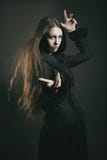 Beautiful young witch casting a spell stock images Beautiful young witch casting a spell stock images