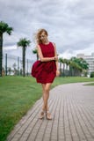 Beautiful young woman blonde with long hair in fashionable burgundy dress royalty free stock image Beautiful young woman blonde with long hair in fashionable burgundy dress royalty free stock image