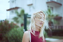 Beautiful young woman blonde with long hair in a fashionable burgundy dress stock photos Beautiful young woman blonde with long hair in a fashionable burgundy dress stock photos