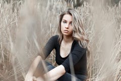 Beautiful young woman blonde in stylish jeans in a fashionable black shirt is resting royalty free stock images Beautiful young woman blonde in stylish jeans in a fashionable black shirt is resting royalty free stock images