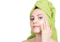 Beautiful Young woman dressed in a bath towel makes cosmetic mask on the face. beauty industry and home skin care royalty free stock photos Beautiful Young woman dressed in a bath towel makes cosmetic mask on the face. beauty industry and home skin care royalty free stock photos
