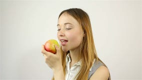 Beautiful young woman eating a red apple stock footage Beautiful young woman eating a red apple stock footage