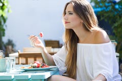 Beautiful young woman eating salad in the home garden. Stock Images Beautiful young woman eating salad in the home garden. Stock Images