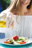 Beautiful young woman eating salad in the home garden. Stock Photos Beautiful young woman eating salad in the home garden. Stock Photos