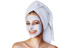 Beautiful young woman with facial mask on her face. Skin care and treatment, spa, natural beauty and cosmetology concept, isolated stock photo Beautiful young woman with facial mask on her face. Skin care and treatment, spa, natural beauty and cosmetology concept, isolated stock photo