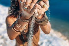 Beautiful young woman holding sand in her hands on the beach stock images Beautiful young woman holding sand in her hands on the beach stock images