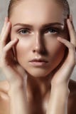 Beautiful young woman with perfect clean shiny skin, natural fashion makeup. Close-up woman, fresh spa look Royalty Free Stock Images Beautiful young woman with perfect clean shiny skin, natural fashion makeup. Close-up woman, fresh spa look Royalty Free Stock Images