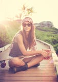 Beautiful young woman posing with a skateboard stock image Beautiful young woman posing with a skateboard stock image