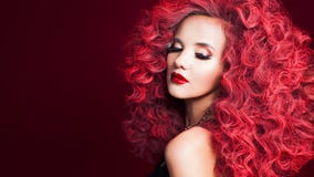 Beautiful young woman with red hair. Bright make-up and hairstyle.