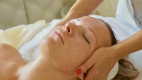 Beautiful young woman relaxing with face massage at luxury spa salon, close-up. royalty free stock images Beautiful young woman relaxing with face massage at luxury spa salon, close-up. royalty free stock images
