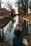 Beautiful young woman relaxing near a canal river in a park near the palace in Rundale, Latvia, 2019 stock photos Beautiful young woman relaxing near a canal river in a park near the palace in Rundale, Latvia, 2019 stock photos