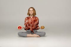 Beautiful young woman sitting in yoga position and meditating stock photography Beautiful young woman sitting in yoga position and meditating stock photography