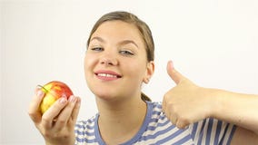 Beautiful young woman smelling a red apple. stock video Beautiful young woman smelling a red apple. stock video
