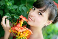 Beautiful Young Woman Smells Flowers In A Garden Royalty Free Stock Photography Beautiful Young Woman Smells Flowers In A Garden Royalty Free Stock Photography