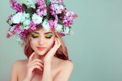 Woman smiling with flowers on head yellow and green eyeshadow closed eyes royalty free stock photography Woman smiling with flowers on head yellow and green eyeshadow closed eyes royalty free stock photography