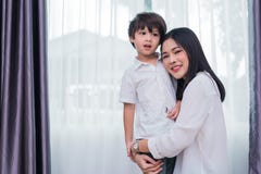 Beauty Asian woman hug and carry her son. Happy family and Home sweet home concept. Love and Lifestyle theme stock images Beauty Asian woman hug and carry her son. Happy family and Home sweet home concept. Love and Lifestyle theme stock images