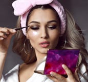 Beauty care woman face close up with patches mask doing makeup royalty free stock photography Beauty care woman face close up with patches mask doing makeup royalty free stock photography