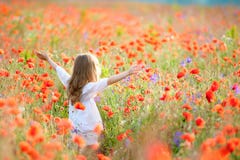 Beauty Girl Outdoors enjoying nature. Beautiful Teenage Model kid in white dress having fun on summer Field with blooming flowers royalty free stock photos Beauty Girl Outdoors enjoying nature. Beautiful Teenage Model kid in white dress having fun on summer Field with blooming flowers royalty free stock photos