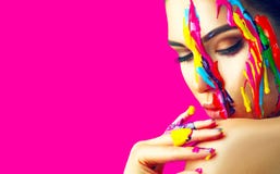 Beauty model girl with colorful paint on her face. Portrait of beautiful woman with flowing liquid paint Royalty Free Stock Photo Beauty model girl with colorful paint on her face. Portrait of beautiful woman with flowing liquid paint Royalty Free Stock Photo