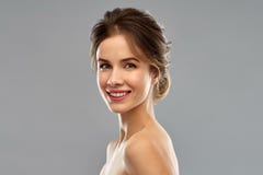 Smiling young woman over grey background royalty free stock photography Smiling young woman over grey background royalty free stock photography