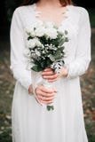 Beauty wedding bouquet of rose flowers and eucalyptus branches in bride`s hands stock photo Beauty wedding bouquet of rose flowers and eucalyptus branches in bride`s hands stock photo